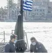  ?? ?? ↑ Greek coastguard officers in the Aegean
