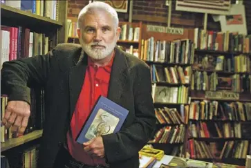  ?? Annie Wells Los Angeles Times ?? MIKE DAVIS, shown in a bookstore in 2004, foreshadow­ed racial and urban strife in his most famous tome “City of Quartz,” which published two years before the L.A. riots and is considered a modern-day classic.