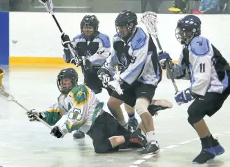  ?? CLIFFORD SKARSTEDT/EXAMINER ?? Ennismore James Gang's Colin McDowall loses control of the ball against Oakville Titans' Mack Abbott, left, Chris Buswell and Jamal Shears during the first period of OLA Senior B Lacrosse home opener on Saturday at the Robert E. Young Recreation...