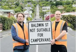  ?? PHOTO: LINDA ROBERTSON ?? New rules, count them . . . Dunedin City Council transport and engineer road safety team leader Hjarne Poulsen (left) and transport engineer Blair McKeever show off a new sign erected in Baldwin St yesterday.