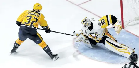  ?? PATRICK SMITH/GETTY IMAGES ?? Nashville’s Frederick Gaudreau tries to backhand the puck past Pittsburgh goalie Matt Murray during Game 3 of the Stanley Cup final. After three games, Gaudreau was leading the Predators with two goals in the Cup final.