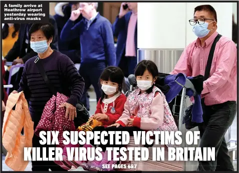  ??  ?? A family arrive at Heathrow airport yesterday wearing anti-virus masks