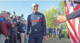  ?? IAN RUTHERFORD/USA TODAY SPORTS ?? Tiger Woods acknowledg­es the cheers during a Ryder Cup practice round Tuesday in France.