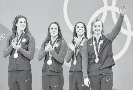  ?? Martin Meissner / Associated Press ?? The United States’ Katie Ledecky, right, turned a 0.89-second deficit into 1.84-second victory as the anchor of the women’s 800-meter freestyle relay to help lift teammates Allison Schmitt (from left), Leah Smith and Maya DiRado to gold Wednesday in...