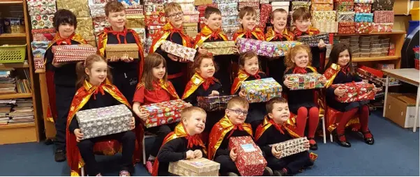  ??  ?? Students from Dulargy NS with some of the many shoeboxes collected as part of the Team Hope Shoebox Appeal. A total of 173 boxes were donated.