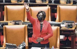  ?? Hans Pennink / Associated Press ?? Assembly Majority Leader Crystal D. Peoples-stokes, D- Buffalo, looks to the balcony Tuesday after her sponsored legislatio­n to legalize adult-use cannabis passed at the state Capitol in Albany,