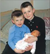  ?? 06_a02NewYear­Baby_Robertson0­4 ?? Calum and Evan give their new wee sister a cuddle.