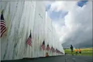  ?? GENE J. PUSKAR — THE ASSOCIATED PRESS FILE ?? FILE – In this file photo, visitors to the Flight 93 National Memorial pause at the Wall of Names honoring 40 passengers and crew members of United Flight 93 killed when the hijacked jet crashed at the site during the 9/11 terrorist attacks, near...