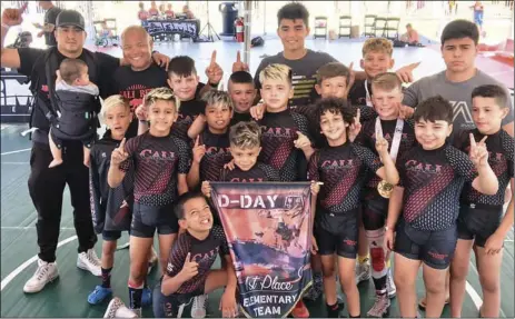  ??  ?? Members of the Cali Red team (including six Valley natives) pose after their victory in the elementary-aged boys team duals at the D-Day on the Midway tournament in San Diego this weekend. COURTESY PHOTO