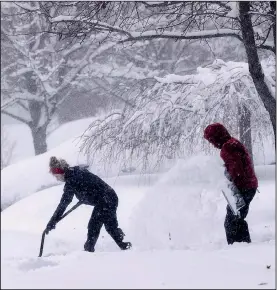  ?? AP/CHUCK BURTON ?? A couple shovel snow from their driveway Sunday in Greensboro, N.C. A strong winter storm brought icy roads, heavy snowfall and power failures throughout the South over the weekend.