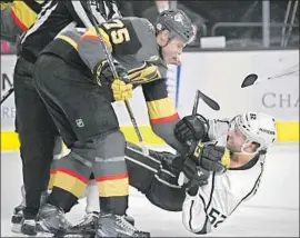  ?? Ethan Miller Getty Images ?? RYAN REAVES of the Golden Knights shoves the Kings’ Michael Amadio to the ice during the first period. Reaves also took a couple of penalties.