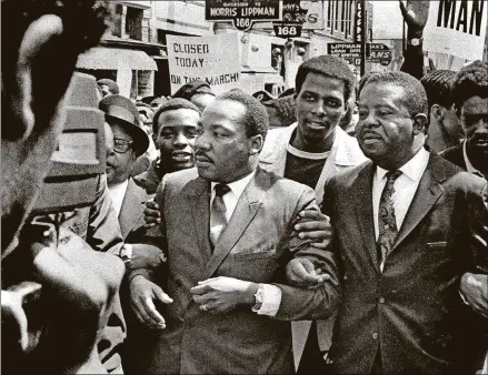  ?? SAM MELHORN/THE COMMERCIAL APPEAL VIA AP ?? In this March 28, 1968, file photo, Dr. Martin Luther King Jr. and Rev. Ralph Abernathy, right, lead a march on behalf of striking Memphis, Tenn., sanitation workers.