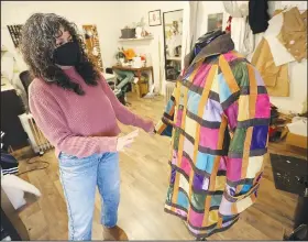  ?? (NWA Democrat-Gazette/David Gottschalk) ?? Designer Brandy Lee displays one of her coats Tuesday at her studio in Fayettevil­le. Go to nwaonline.com/210104Dail­y/ to see more photos.