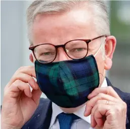 ??  ?? Tartan face mask: Michael Gove in Glasgow yesterday