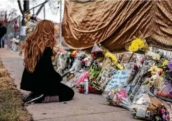  ?? Photos by Chet Strange / TNS ?? A mourner visits the location where a gunman opened fire at a supermarke­t on Monday in Boulder, Colo. The 10 people killed include Boulder police officer Eric Talley, 51, who was the first on the scene.
