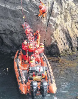  ?? PHOTOS BY JOE GIBBONS/THE TELEGRAM ?? A training exercise was held near Quidi Vidi on Thursday involving all of the local first-responder agencies that work on land, sea and air. The scenarios involved lowering a patient down a cliffside to a waiting fast-rescue craft by members of the St. John’s Regional Fire Department’s high-angle rescue team, a lost hiker being airlifted by paramedics via a Universal helicopter and a person in distress airlifted by medics in a Cougar Helicopter search and rescue chopper.
