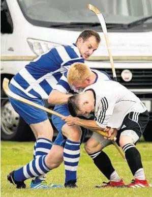  ??  ?? Three’s a crowd: Lovat’s Craig Mainland, right, tries to fend off two opponents Oban Camanachd will go into this weekend’s Cameron Consultanc­y Celtic Society Cup final against Kyles Athletic with a full-strength squad and have avoided suspension­s for...