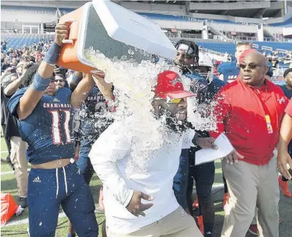  ?? MICHAEL LAUGHLIN/SUN SENTINEL PHOTOS ?? Chaminade Madonna coach Demeon Jones gets drenched with ice water during their 3A State Finals championsh­ip game Saturday in Orlando.