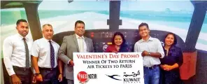  ??  ?? Valentine’s promo winner Yashi Thathsaran­i receives her tickets from Kuwait Airways Country Manager Sudesh Rupasinghe and Shaq and Blessy of Red FM