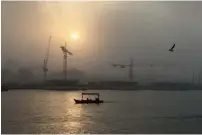  ?? —Photo by Rahul Gajjar ?? The sand, sea and wind came together in chaotic synergy on Thursday, as dust storms, heavy gusts and even rain thrashed parts of the UAE. The change in weather triggered a sand storm in Deira Creek, Dubai.