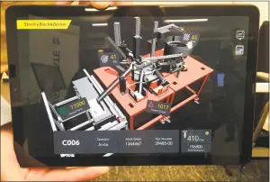  ??  ?? At the new Stanley Black & Decker Manufactor­y 4.0 center in downtown Hartford, a tablet shows a schematic diagram of a sorting machine in a factory with live updated analytics. The center will allow engineers to work with factory managers from around the world on advanced analytics and workflow design. The location had its grand opening Thursday.