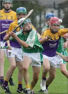  ??  ?? Shane Flood of Naomh Eanna about to strike despite the close attention of Eoin Hartigan (Faythe Harriers).