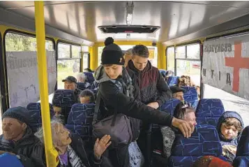  ?? EVGENIY MALOLETKA AP ?? People ride in the bus during an evacuation Wednesday near the city of Lyman in eastern Ukraine.