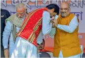  ?? — PTI ?? BJP president Amit Shah greets Biplab Kumar Deb after he was sworn in as the 10th chief minister of Tripura in Agartala on Friday. Prime Minister Narendra Modi is also seen.