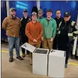  ?? SUBMITTED ?? From left, LCJVS Welding and Fabricatio­n instructor Tony Tyree; senior students in the LCJVS Welding and Fabricatio­n program, Amherst Assistant Fire Chief, Brandon Dimacchia and Amherst Fire Chief Jim Wilhelm stand by the storage lockers.