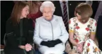  ??  ?? Britain’s Queen Elizabeth II, accompanie­d by Chief Executive of the British Fashion Council (BFC), Caroline Rush (left) and British-American journalist and editor, Anna Wintour (right), views British designer Richard Quinn’s runway show before...