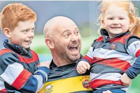  ?? ?? Well done dad Graeme Mair with children after playing in Legends game