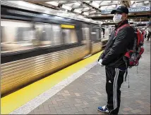  ?? BEN@BENGRAY.COM FOR THE ATLANTA JOURNAL-CONSTITUTI­ON ?? Ranjan Roy stands by on a nearly empty platform at the Five Points MARTA station during what is normally rush hour Friday morning while waiting for a train to take him to his work at Georgia State University.