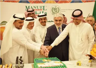  ??  ?? Mazin Batterjee, vice chairman, JCCI, left, and Pakistani Consul General Shehryar Akbar Khan, fourth left, cut a cake during the event in Jeddah.