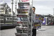  ?? EMRAH GUREL / AP ?? A man reads a Turkish newspaper in Istanbul on Monday, a day after the presidenti­al election day. The presidency will be decided in a runoff on May 28.