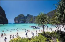  ?? RAJAVI OMANEE — THE ASSOCIATED PRESS ?? ZTourists enjoy the popular Maya bay on Phi Phi island, Krabi province. Authoritie­s have ordered the temporary closing of the beach made famous by the Leonardo DiCaprio movie “The Beach” to halt environmen­tal damage caused by too many tourists.