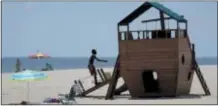  ?? JULIO CORTEZ — THE ASSOCIATED PRESS ?? A child plays on a makeshift ship during a beach outing, Friday in Long Branch, N.J. New Jersey Gov. Phil Murphy signed a bill on Friday, banning smoking on beaches and parks.