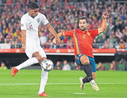  ?? Picture: Getty Images. ?? Marcus Rashford scores England’s second goal despite the efforts of Spain defender Jonny.