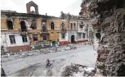  ?? ASSOCIATED PRESS ?? Children walk among buildings destroyed during fighting in Mariupol, in territory under the government of the Donetsk People’s Republic, eastern Ukraine, on Wednesday.