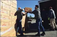  ?? Erik Trautmann / Hearst Connecticu­t Media ?? Volunteers load a truck to distribute food under the U.S. Department of Agricultur­e’s Farmers to Families Food Boxes program on Oct. 8 in Norwalk.