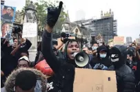  ?? DANIEL LEAL-OLIVAS AFP/GETTY IMAGES ?? “Star Wars” actor John Boyega speaks to protesters during an anti-racism demonstrat­ion in London on Wednesday.