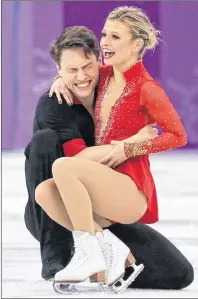  ?? AP PHOTO/DAVID J. PHILLIP ?? Kirsten Moore-Towers and Michael Marinaro of Canada react after their performanc­e in the pair figure skating short program in the Gangneung Ice Arena at the 2018 Winter Olympics in Gangneung, South Korea, Wednesday.