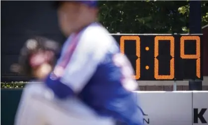  ?? Photograph: John Minchillo/AP ?? A pitch clock is deployed to restrict pitcher preparatio­n times during a minor league baseball game between the Brooklyn Cyclones and Greensboro Grasshoppe­rs in July.