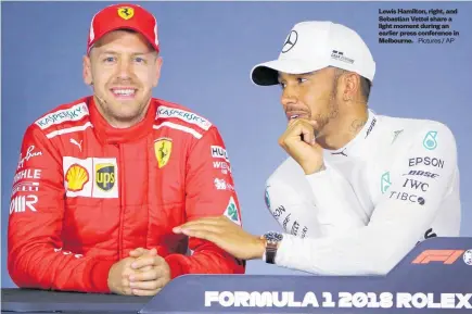  ?? Pictures / AP ?? Lewis Hamilton, right, and Sebastian Vettel share a light moment during an earlier press conference in Melbourne.