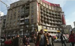  ?? SEAN GALLUP/GETTY IMAGES ?? A street scene in Bucharest. Romania has been part of the European Union since 2007, but the right of its citizenry to work within the EU was restricted for years.