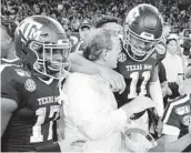  ?? MICHAEL WYKE AP ?? Texas A&M receiver Ainias Smith (17), coach Jimbo Fisher and QB Kellen Mond (11) celebrate victory.