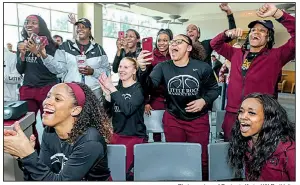  ?? Photo courtesy of Benjamin Krain, UALR athletics ?? UALR players react during a NCAA Tournament watch party Monday at the Jack Stephens Center in Little Rock. The Trojans will play Gonzaga on Saturday.