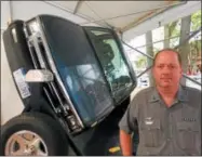  ?? PAUL POST — PPOST@DIGITALFIR­STMEDIA.COM ?? Trooper Steve Rothwein demonstrat­ed a vehicle rollover device. He is Troop G’s school and community outreach coordinato­r.