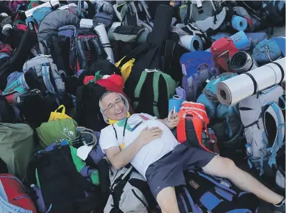  ??  ?? A smiling pilgrim lies on rucksacks as he waits for his transport to a vigil prayer held by Pope Francis at Campus Misericord­iae in Brzegi, near Krakow yesterday. The 79-year-old Francis has had an unrelentin­g schedule since he arrived in Poland on...