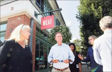  ?? Christian Abraham / Hearst Connecticu­t Media ?? Gov. Ned Lamont and First Selectman Jayme Stevenson, left, tour businesses damaged by flooding from Hurricane Ida in Darien on Friday.