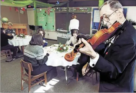  ?? FILE PHOTO ?? Santo Fragilio was band director at Middletown High School and a musical institutio­n in the city. He died Tuesday at home at age 92. In this 2001 photograph, Fragilio serenades teachers and staff at Wesley School in Middletown during a lunch in their...
